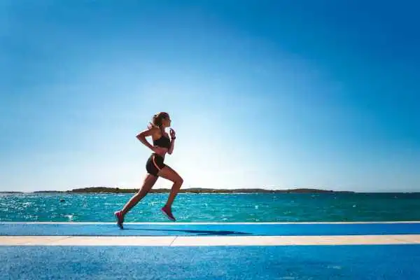 Woman running showing strong leg muscle Market Mowbray